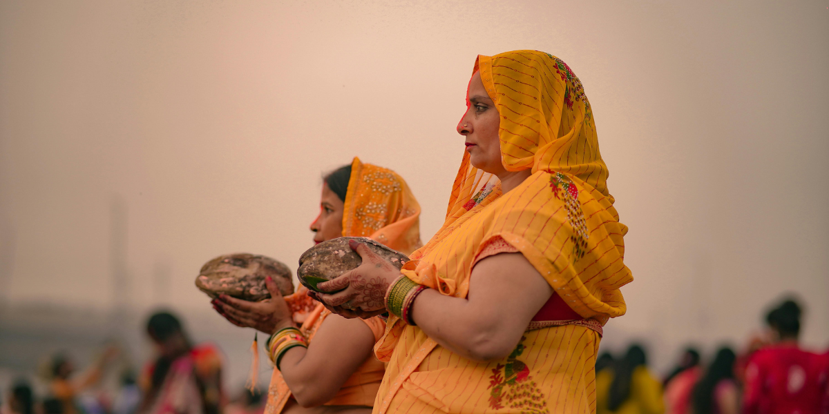 The women are doing chhath puja at the banks of river ganga